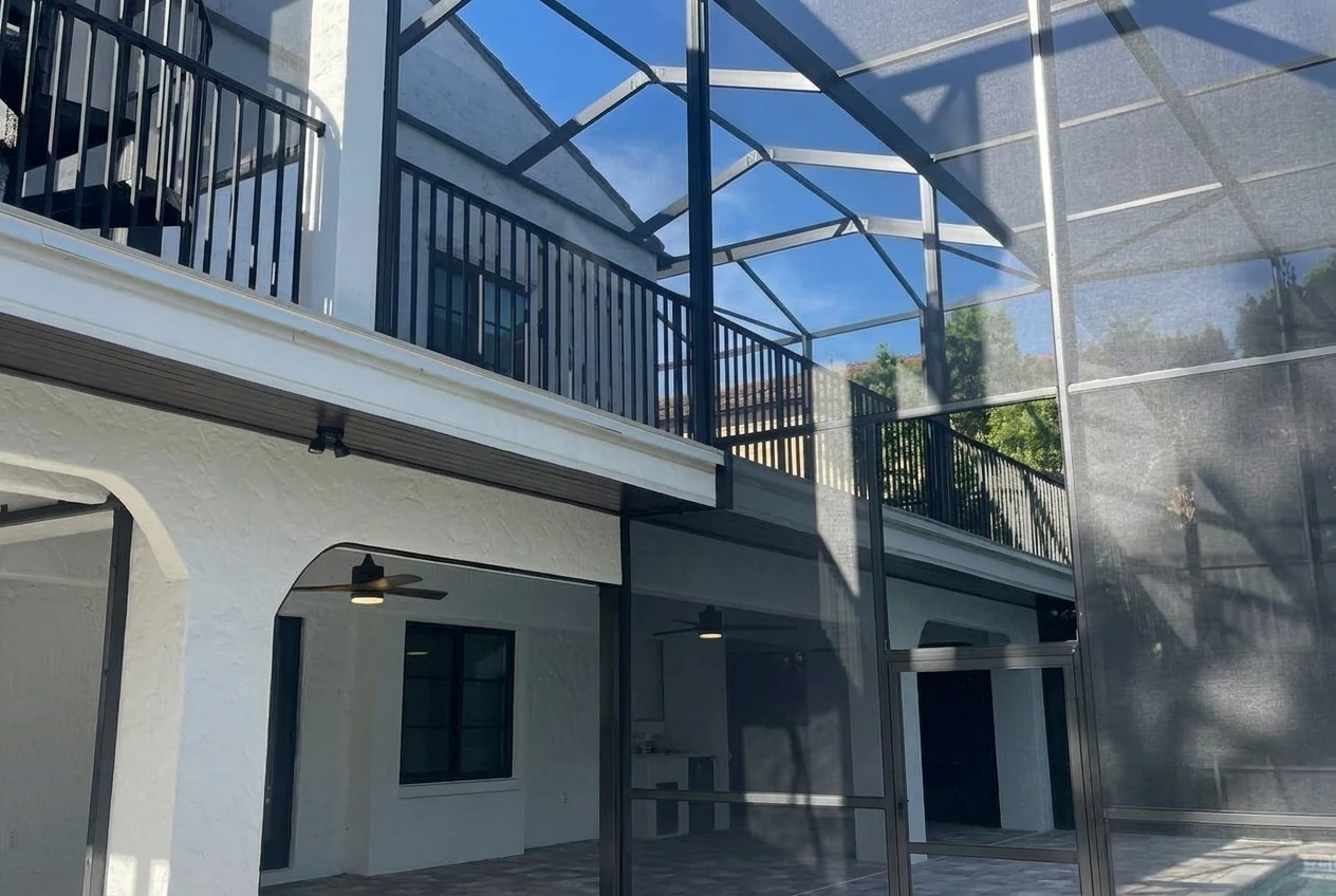 The photo shows a two-story screen enclosure that was custom-designed according to the client’s needs.