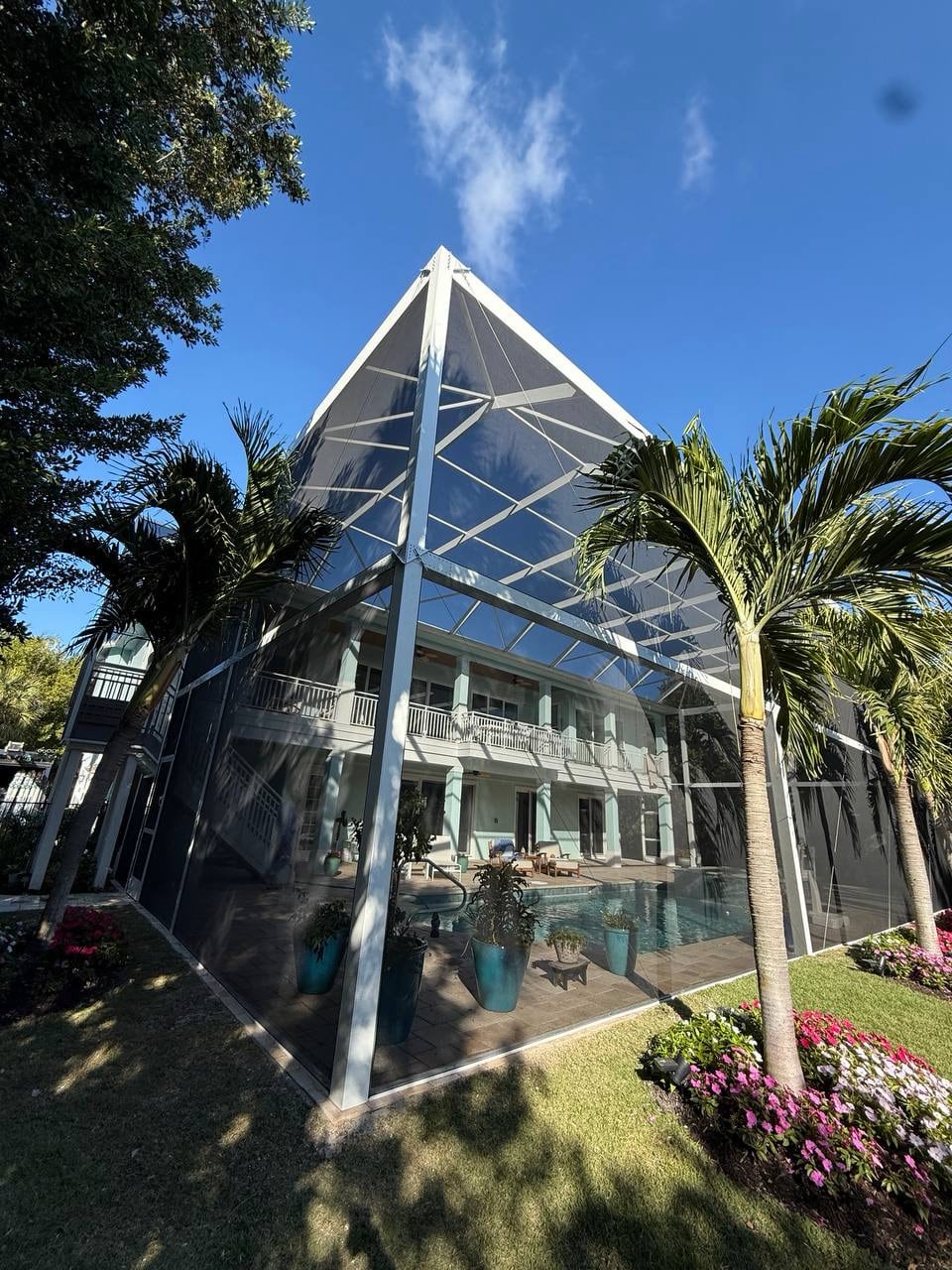 Tall gable roof design of a two story pool screen enclosure