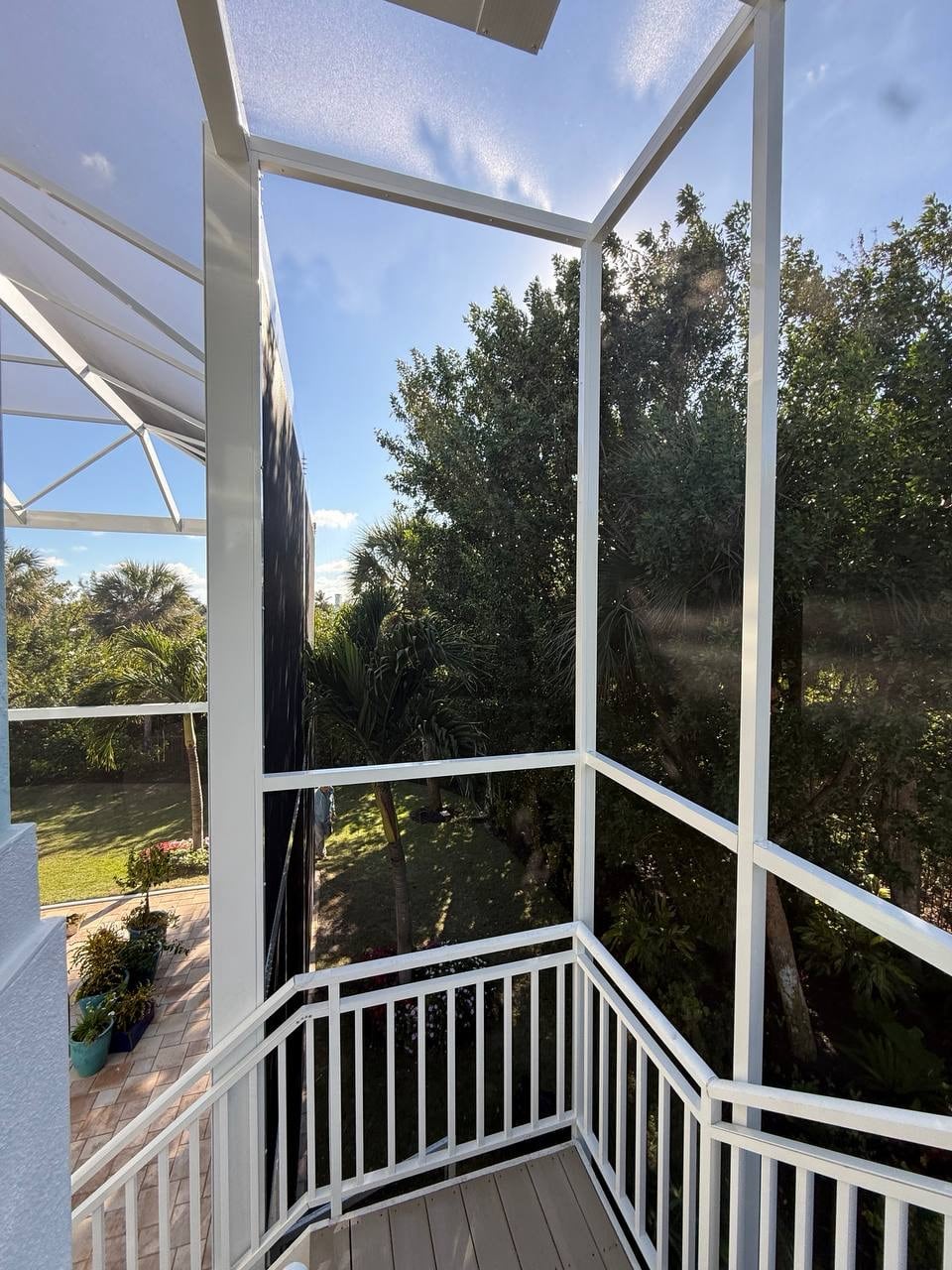 Screen enclosure wall built around the pool deck and exterior staircase