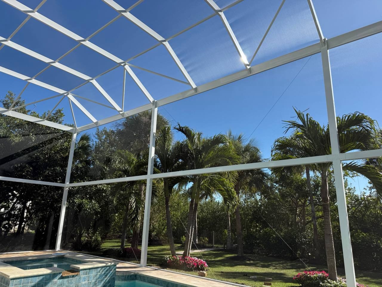Screened staircase and outdoor lighting inside the pool enclosure