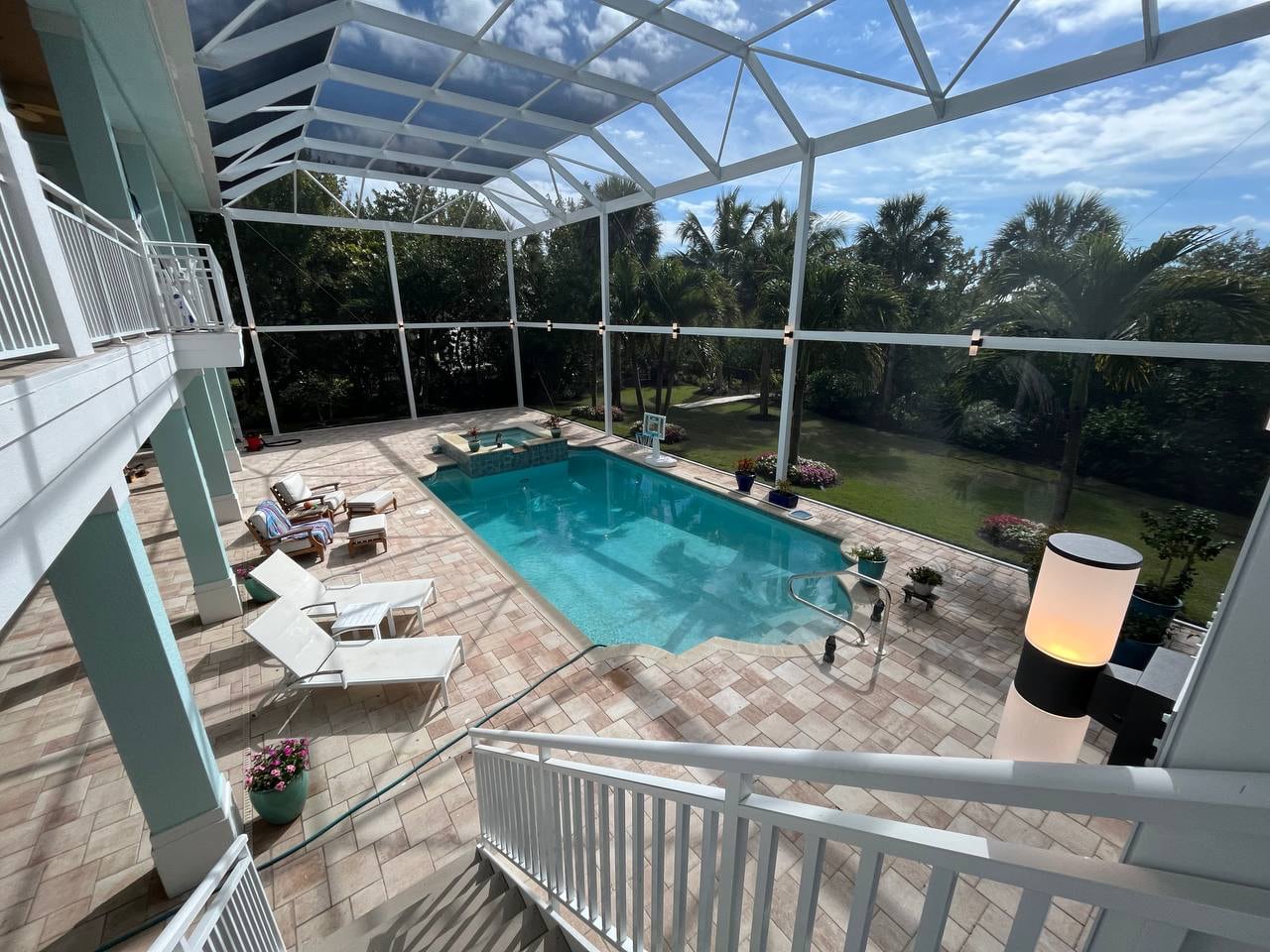 Two-story pool enclosure with integrated lighting in Sanibel