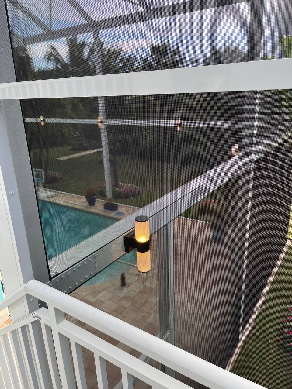 Light fixtures mounted on the aluminum pool cage frame
