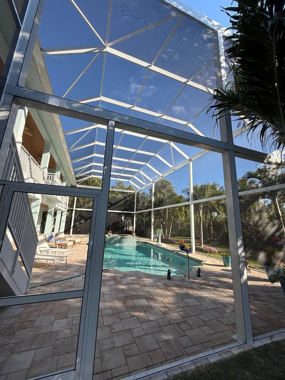 White aluminum framework of a custom two story pool cage