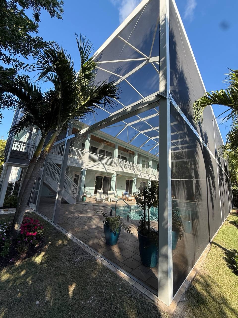Exterior view of the custom pool cage and second floor balcony